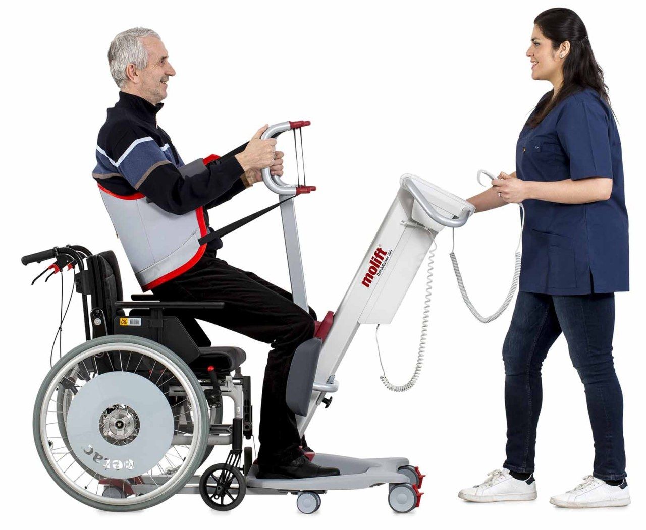 A carer helping a man stand from his wheelchair with a sit-to-stand hoist